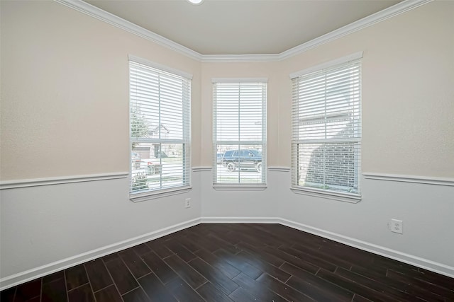 unfurnished room with ornamental molding, dark wood-type flooring, and baseboards