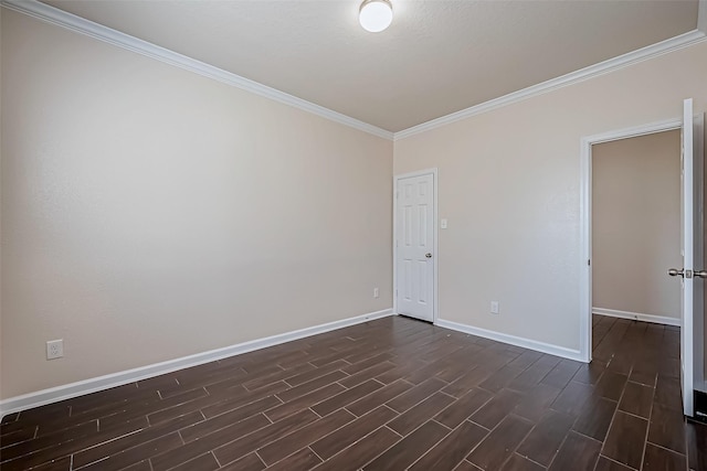 empty room featuring baseboards, dark wood-style flooring, and ornamental molding