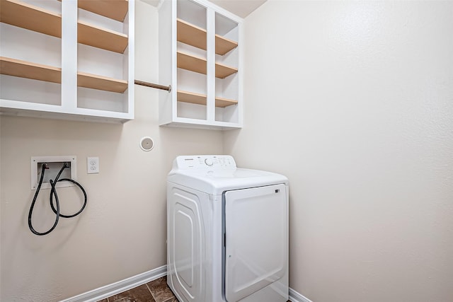 clothes washing area with laundry area, washer / dryer, and baseboards