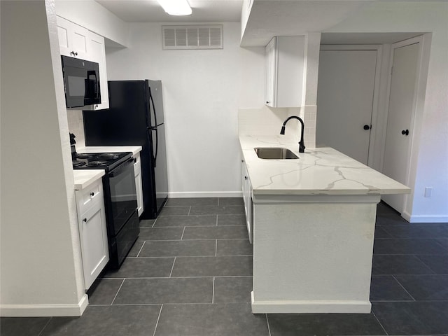 kitchen featuring white cabinets, light stone countertops, sink, and black appliances