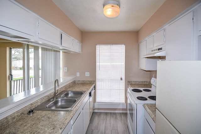 kitchen with white cabinetry, sink, and white appliances