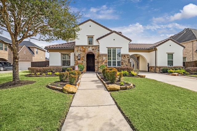 mediterranean / spanish-style house featuring a front lawn