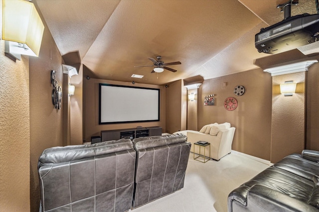 carpeted cinema with a textured ceiling, vaulted ceiling, and ceiling fan