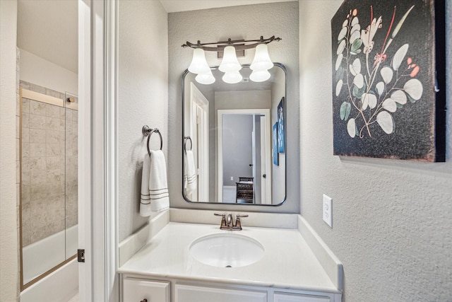 bathroom with vanity and combined bath / shower with glass door