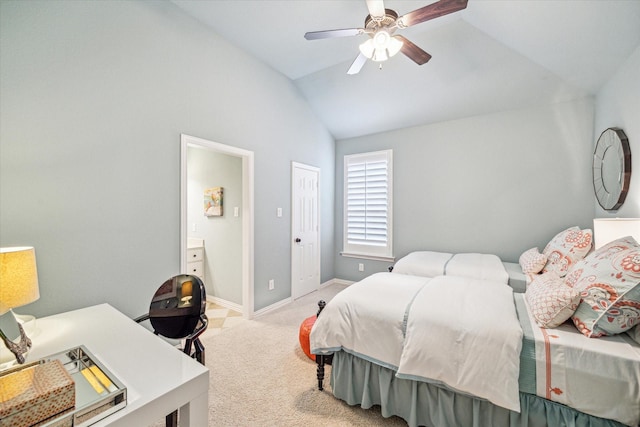 bedroom with light carpet, ensuite bath, vaulted ceiling, and ceiling fan