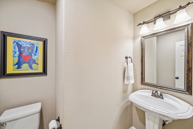 bathroom featuring toilet and sink