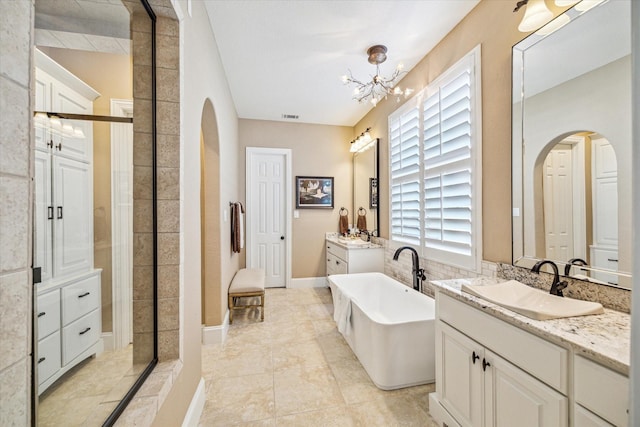 bathroom featuring shower with separate bathtub, tile patterned floors, vanity, and an inviting chandelier