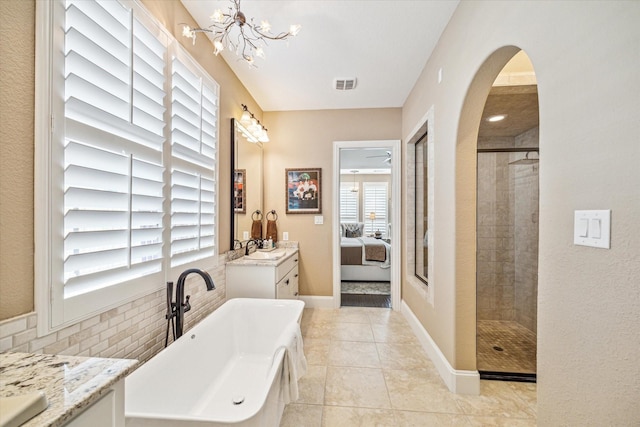 bathroom with vanity, tile patterned floors, shower with separate bathtub, and a chandelier