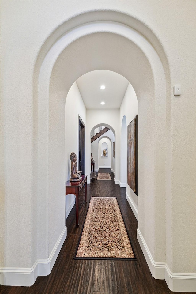 corridor featuring dark wood-type flooring