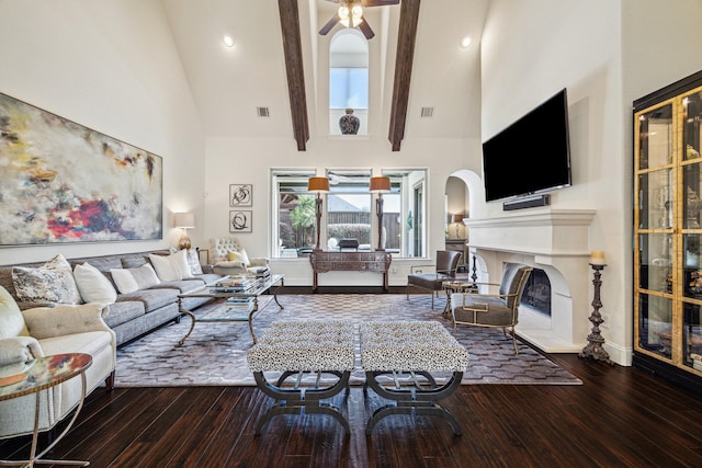 living room featuring wood-type flooring, high vaulted ceiling, and beamed ceiling