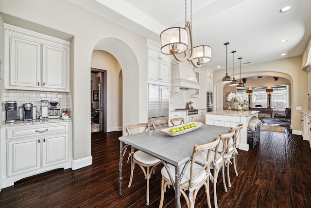 dining room featuring dark hardwood / wood-style floors and a chandelier