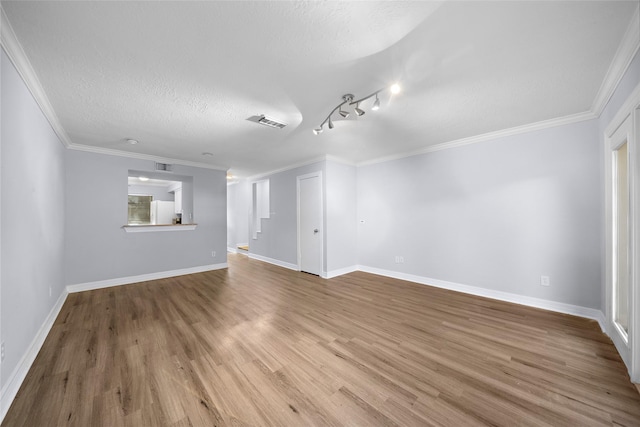 unfurnished living room with crown molding, hardwood / wood-style flooring, and a textured ceiling