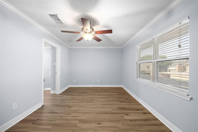 empty room featuring crown molding, dark wood-type flooring, a textured ceiling, and ceiling fan