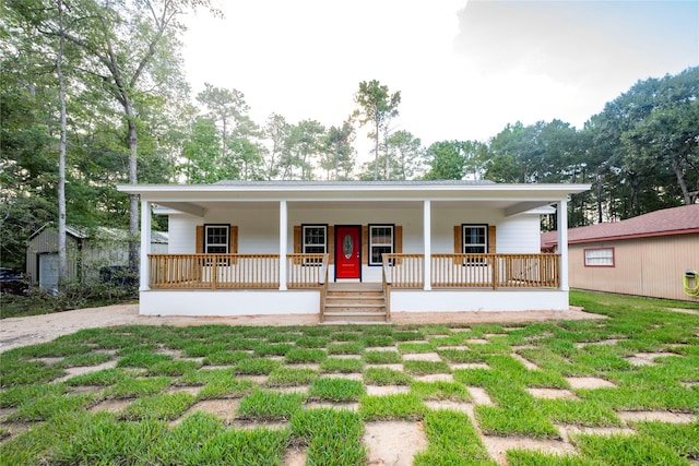 view of front of home featuring a front lawn and a porch