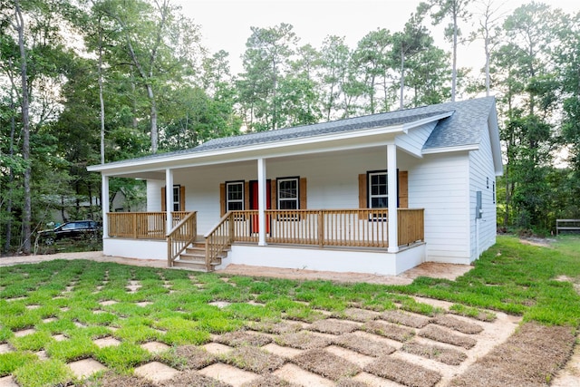 view of front of house with a porch and a front lawn