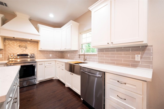 kitchen featuring premium range hood, white cabinetry, tasteful backsplash, dark hardwood / wood-style floors, and stainless steel appliances