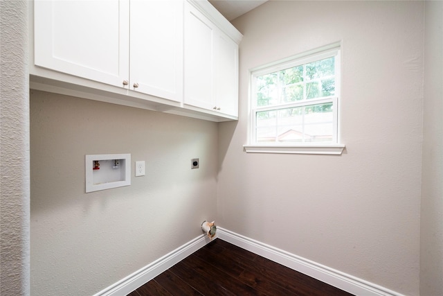 laundry room featuring electric dryer hookup, hookup for a washing machine, dark hardwood / wood-style flooring, and cabinets