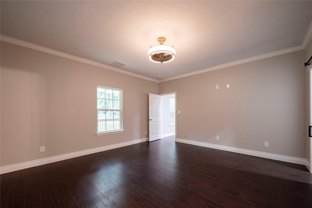 spare room featuring ornamental molding and dark hardwood / wood-style floors