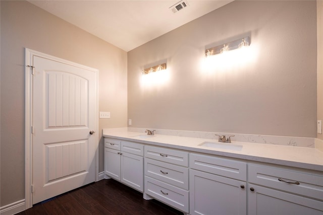 bathroom with hardwood / wood-style flooring and vanity