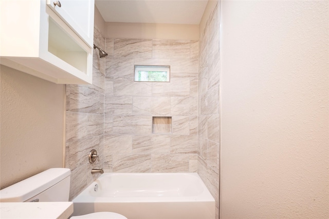 full bathroom with vanity, tiled shower / bath, and toilet