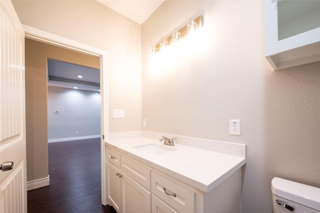 bathroom featuring hardwood / wood-style flooring, vanity, and toilet