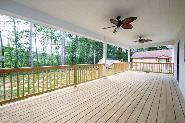 deck featuring ceiling fan and a storage shed