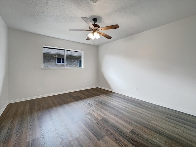 empty room with ceiling fan, dark hardwood / wood-style flooring, and a textured ceiling