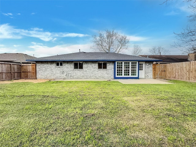 back of property with a patio and a lawn