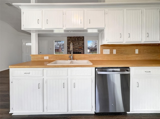 kitchen featuring sink, stainless steel dishwasher, and white cabinets