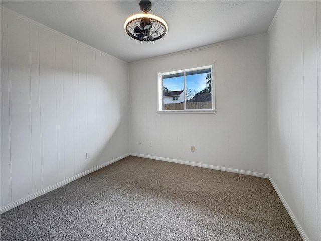 empty room with ornamental molding and carpet floors