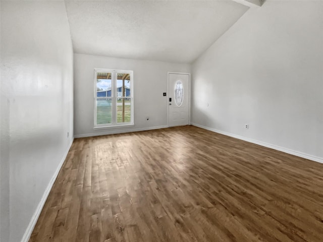 interior space with lofted ceiling and dark wood-type flooring