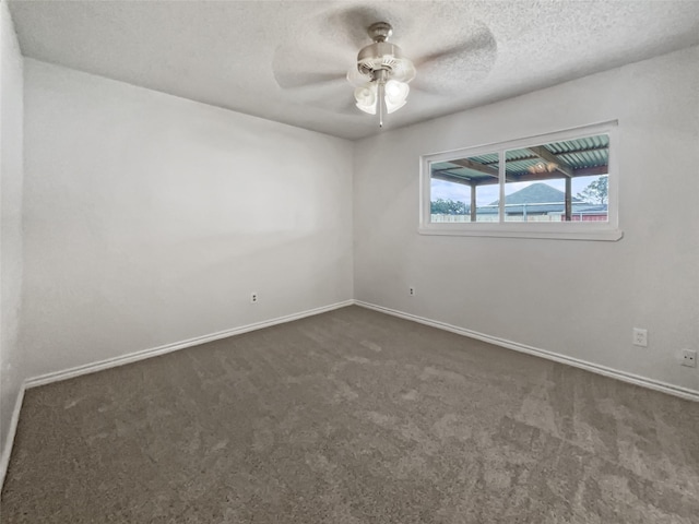 5210 3rd St, Danbury, TX 77534 - unfurnished room featuring dark carpet, ceiling fan, baseboards, and a textured ceiling