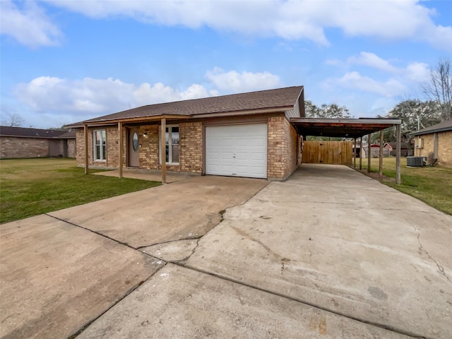 5210 3rd St, Danbury, TX 77534 - view of front of home featuring brick siding, a carport, a garage, concrete driveway, and a shingled roof