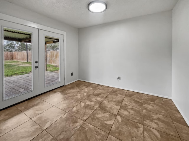 5210 3rd St, Danbury, TX 77534 - tiled empty room with french doors and baseboards