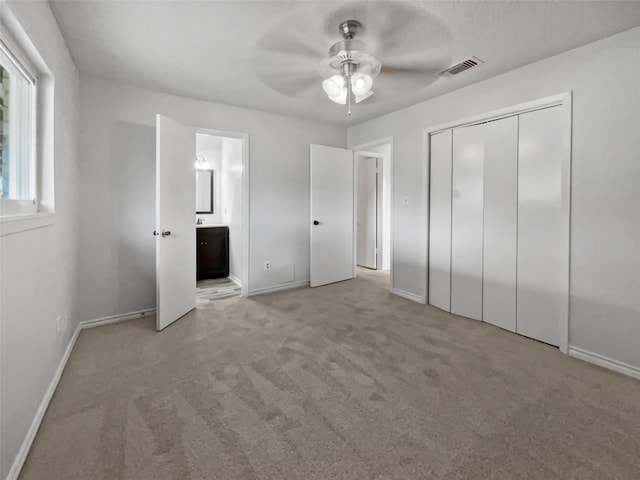 5210 3rd St, Danbury, TX 77534 - unfurnished bedroom with baseboards, carpet, ensuite bath, and a ceiling fan