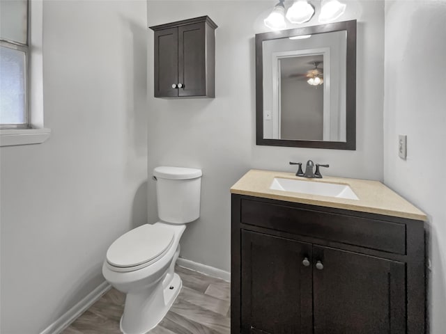 5210 3rd St, Danbury, TX 77534 - bathroom with baseboards, vanity, toilet, and ceiling fan