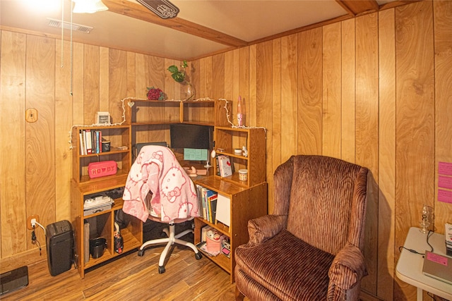 office space with wood-type flooring and wood walls