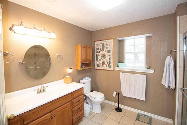 bathroom featuring toilet, an enclosed shower, a textured ceiling, vanity, and tile patterned flooring