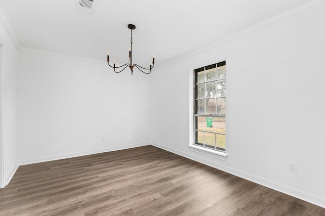 unfurnished dining area with an inviting chandelier, hardwood / wood-style flooring, and ornamental molding