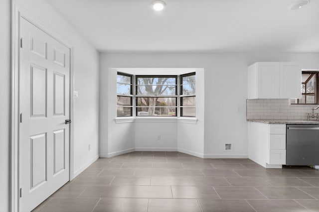 unfurnished dining area with light tile patterned floors