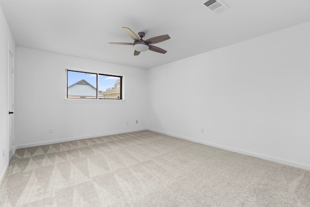 carpeted spare room featuring ceiling fan