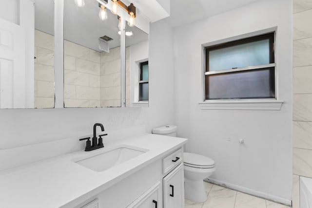 bathroom featuring vanity, toilet, and a shower