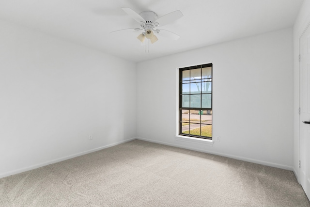 empty room with ceiling fan and carpet floors