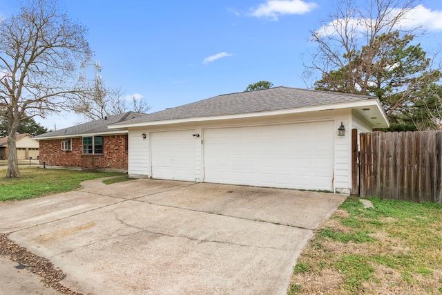 view of side of home featuring a garage and a lawn