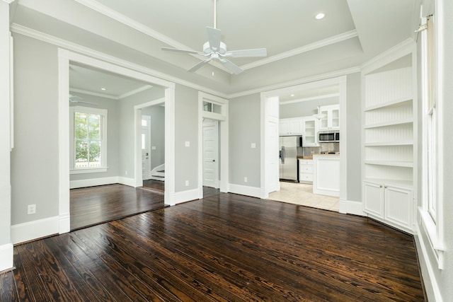 unfurnished living room with crown molding, built in features, ceiling fan, and light wood-type flooring