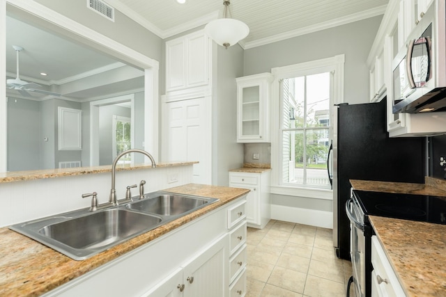 kitchen featuring crown molding, pendant lighting, white cabinets, and electric stove