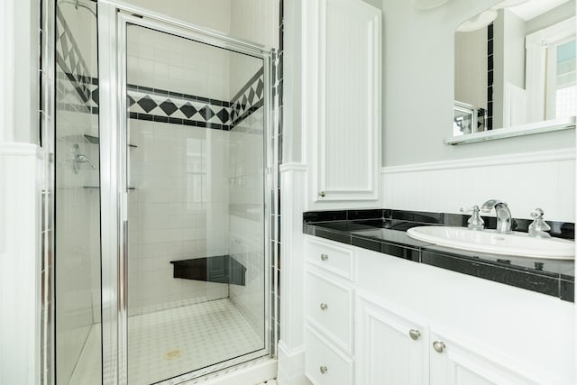 bathroom with vanity and a shower with shower door