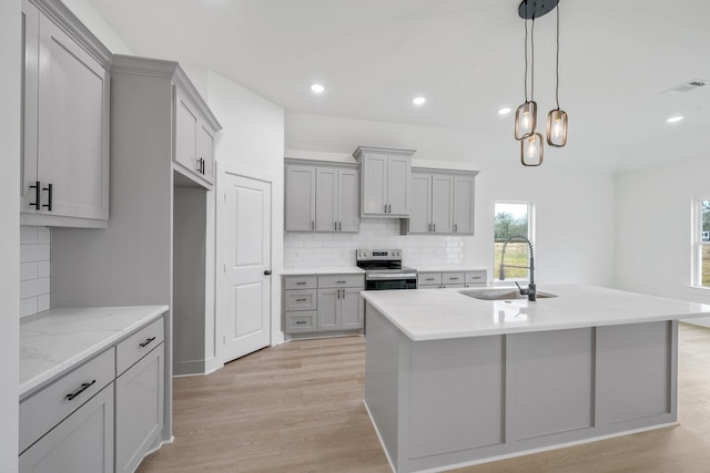 4974 County Road 128, Iola, TX 77861 - kitchen featuring sink, gray cabinetry, light stone counters, light hardwood / wood-style flooring, and electric stove