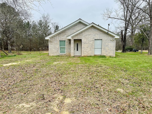 rear view of property featuring a lawn