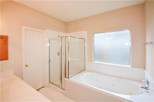 bathroom with vanity and plus walk in shower